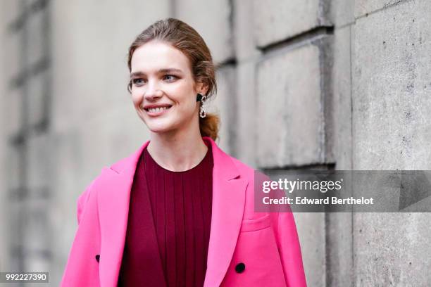 Natalia Vodianova wears a pink blazer jacket, a burgundy red dress, outside Valentino, during Paris Fashion Week Haute Couture Fall Winter 2018/2019,...