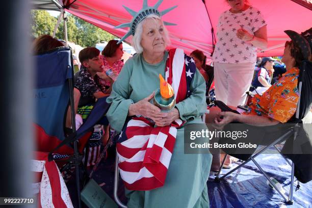Dressed as Lady Liberty Carol Hunt, of Milton, waits for the Boston Pops Fireworks Spectacular to begin at the Hatch Shell on the Esplanade in...