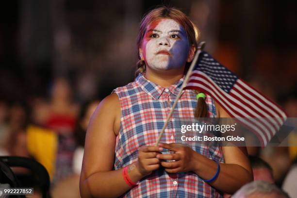 Young girl watches the festivities during the Boston Pops Fireworks Spectacular at the Hatch Shell on the Esplanade in Boston, MA on July 04, 2018.