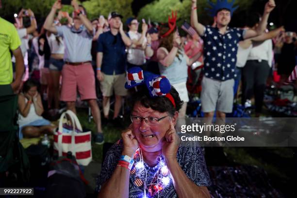 Pamela Mansell of Ipswich reacts to the canon fire during the 1812 Overture during the Boston Pops Fireworks Spectacular at the Hatch Shell on the...
