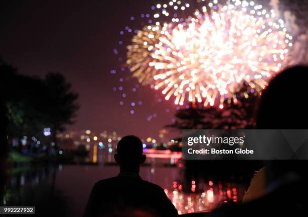 Spectator views the fireworks following the Boston Pops Fireworks Spectacular at the Hatch Shell on the Esplanade in Boston, MA on July 04, 2018.