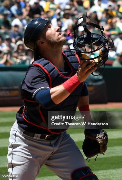 Yan Gomes of the Cleveland Indians reacts to a foul pop-up off the bat of Marcus Semien of the Oakland Athletics in the fifth inning at Oakland...