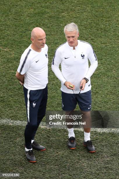 Didier Deschamps, Manager of France speaks to assistant coach Guy Stéphan during a training session at Nizhny Novgorod Stadium on July 5, 2018 in...