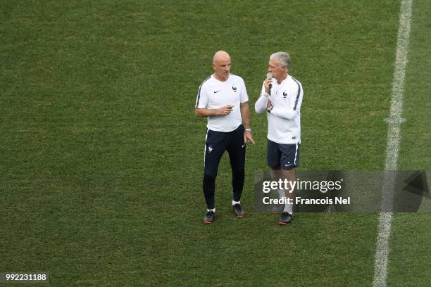 Didier Deschamps, Manager of France speaks to assistant coach Guy Stéphan during a training session at Nizhny Novgorod Stadium on July 5, 2018 in...