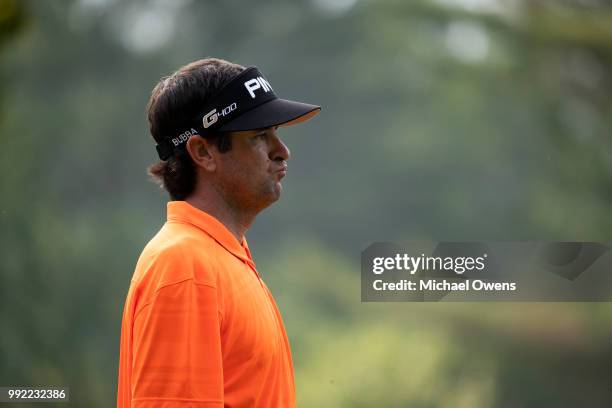 Bubba Watson walks to his second shot on the 12th hole during round one of A Military Tribute At The Greenbrier at the Old White TPC course on July...
