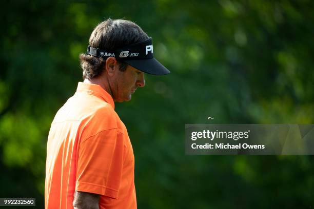 Bubba Watson walks to his second shot on the 12th hole during round one of A Military Tribute At The Greenbrier at the Old White TPC course on July...