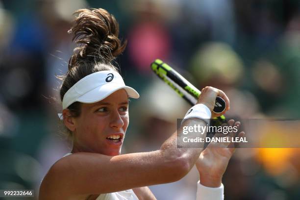 Britain's Johanna Konta returns to Slovakia's Dominika Cibulkova in their women's singles second round match on the fourth day of the 2018 Wimbledon...