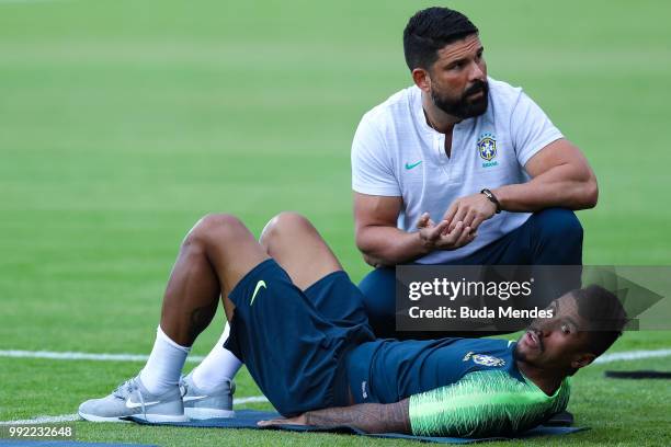 Paulinho recovers with the physiotherapist Bruno Mazziotti during a Brazil training session ahead of the the 2018 FIFA World Cup Russia Quarter Final...