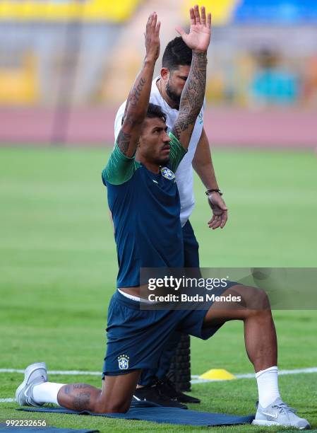 Paulinho recovers with the physiotherapist Bruno Mazziotti during a Brazil training session ahead of the the 2018 FIFA World Cup Russia Quarter Final...