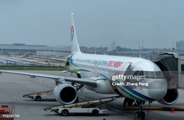 China Eastern Airlines airplane stops on the airport apron, accepting ground service before next taking off. The China Eastern Airlines Co is a...