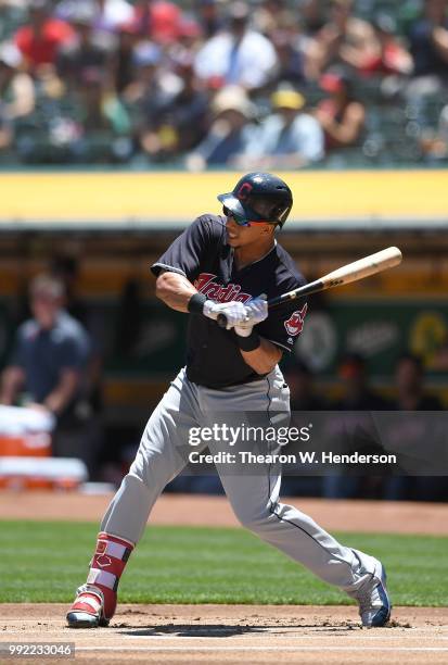 Michael Brantley of the Cleveland Indians bats against the Oakland Athletics in the first inning at Oakland Alameda Coliseum on June 30, 2018 in...