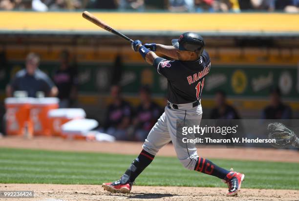 Jose Ramirez of the Cleveland Indians hits a solo home run against the Oakland Athletics in the top of the fourth inning at Oakland Alameda Coliseum...