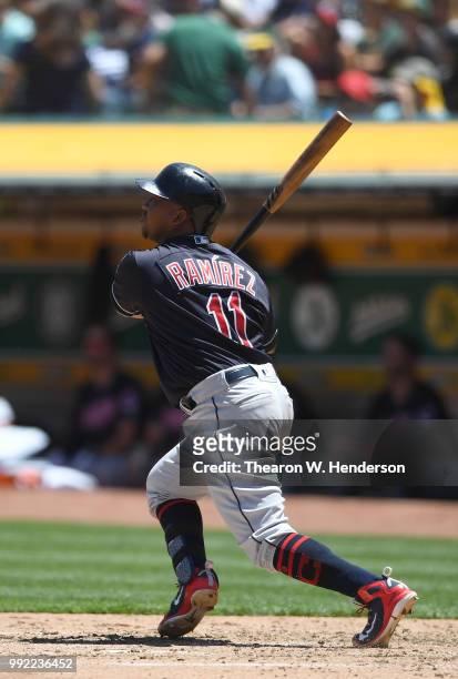 Jose Ramirez of the Cleveland Indians hits a solo home run against the Oakland Athletics in the top of the fourth inning at Oakland Alameda Coliseum...