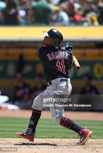 Jose Ramirez of the Cleveland Indians hits a solo home run against the Oakland Athletics in the top of the fourth inning at Oakland Alameda Coliseum...