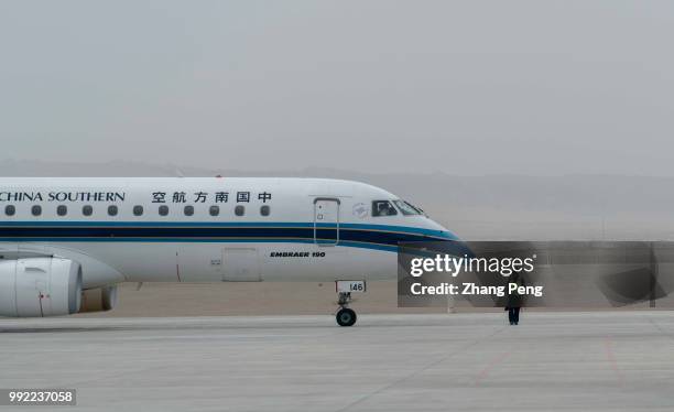 China Southern airlines airplane stops on the airport runway, ready for taking off. China Southern Airlines, based in Guangzhou, founded in March 25...