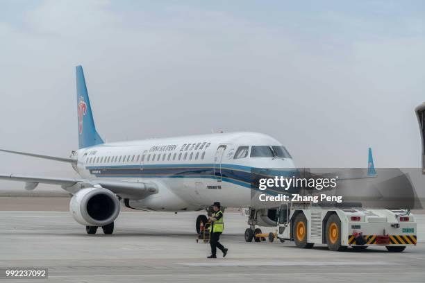 China Southern airlines airplane is pushed to the airport runway, ready for taking off. China Southern Airlines, based in Guangzhou, founded in March...