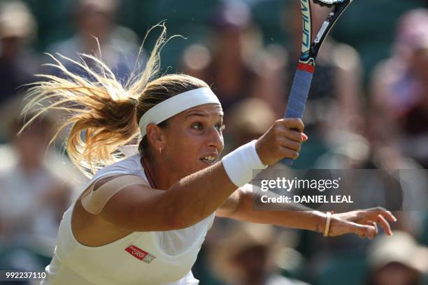 Slovakia's Dominika Cibulkova returns to Britain's Johanna Konta in their women's singles second round match on the fourth day of the 2018 Wimbledon...