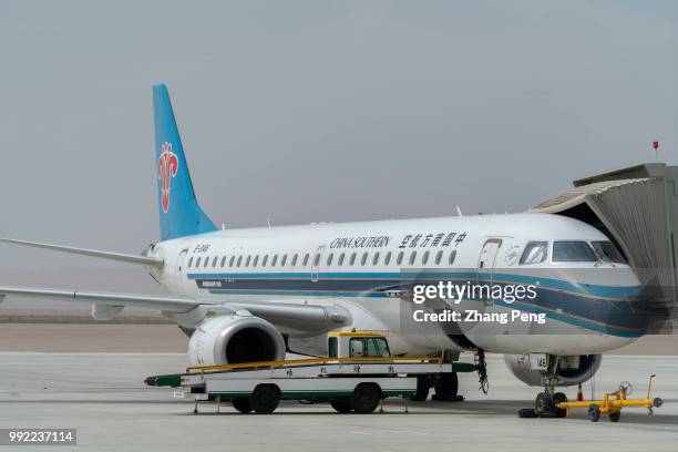 China Southern airlines airplane stops on the airport apron, waiting for passengers boarding. China Southern Airlines, based in Guangzhou, founded in...