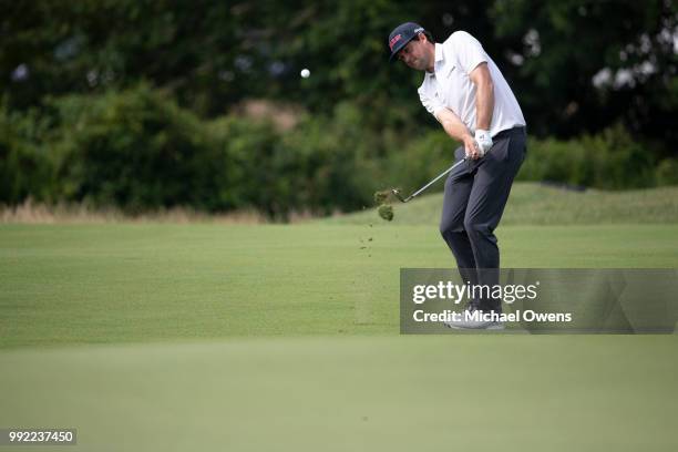 Keegan Bradley chips to the green on the 17th hole during round one of A Military Tribute At The Greenbrier at the Old White TPC course on July 5,...