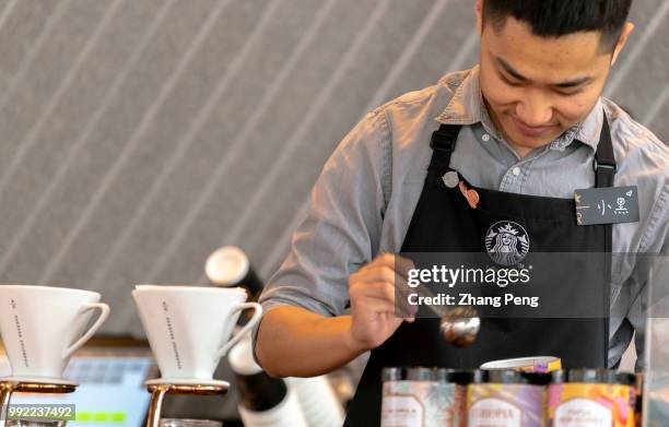 Barista is making coffee in a new Starbucks Reserve coffee shop. At the global investor conference first held in China on May 26, Starbucks announced...