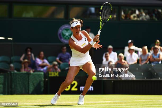 Johanna Konta of Great Britain returns a shot against Dominika Cibulkova of Slovakia during their Ladies' Singles second round match on day four of...