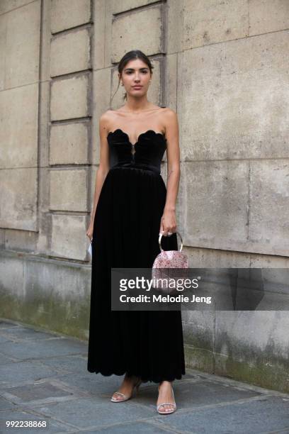 Patricia Manfield in a black dress and pink purse outside Valentino couture on July 4, 2018 in Paris, France.