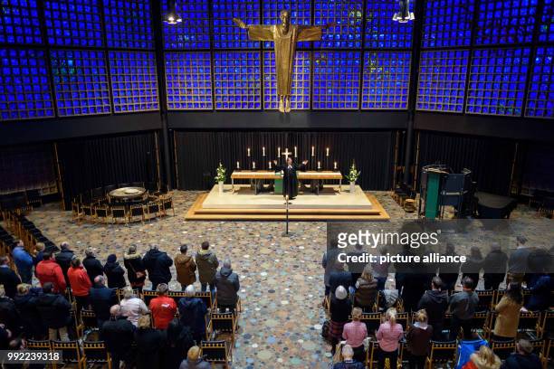 The protestant pastor Martin Germer speaks to stand owners during a service in the Kaiser Wilhelm Memorial Church before the official opening of the...