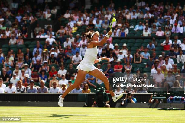 Johanna Konta of Great Britain returns a shot against Dominika Cibulkova of Slovakia during their Ladies' Singles second round match on day four of...