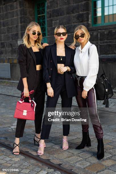 Leonie Hanne, Caro Daur and Xenia Adonts pose during the Marc Cain Street Style shooting at WECC on July 3, 2018 in Berlin, Germany.