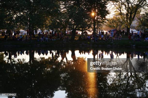 People enjoy the sunset and the shade during the Boston Pops July 4th Fireworks Spectacular in Boston on July 4, 2018.