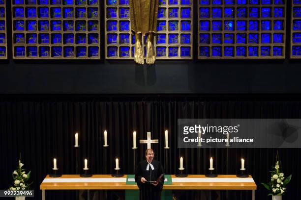 The protestant pastor Martin Germer speaks to stand owners during a service in the Kaiser Wilhelm Memorial Church before the official opening of the...