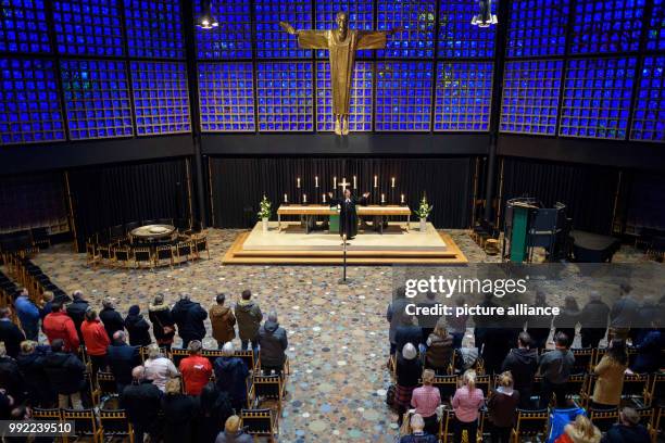 The protestant pastor Martin Germer speaks to stand owners during a service in the Kaiser Wilhelm Memorial Church before the official opening of the...