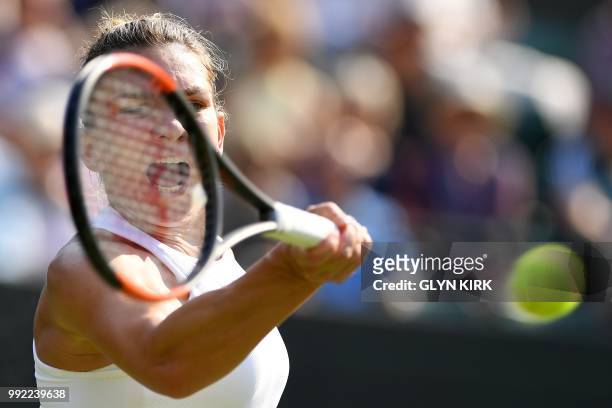 Romania's Simona Halep returns against China's Zheng Saisai during their women's singles second round match on the fourth day of the 2018 Wimbledon...