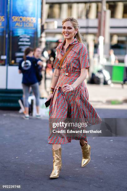Chiara Ferragni wears a flower print colored dress, golden boots, outside Fendi, during Paris Fashion Week Haute Couture Fall Winter 2018/2019, on...