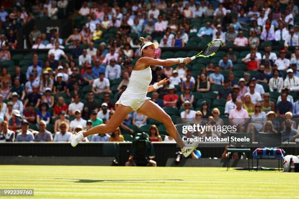 Johanna Konta of Great Britain returns a shot against Dominika Cibulkova of Slovakia during their Ladies' Singles second round match on day four of...