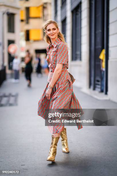 Chiara Ferragni wears a flower print colored dress, golden boots, outside Fendi, during Paris Fashion Week Haute Couture Fall Winter 2018/2019, on...