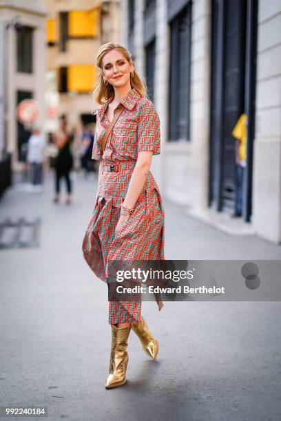 Chiara Ferragni wears a flower print colored dress, golden boots, outside Fendi, during Paris Fashion Week Haute Couture Fall Winter 2018/2019, on...