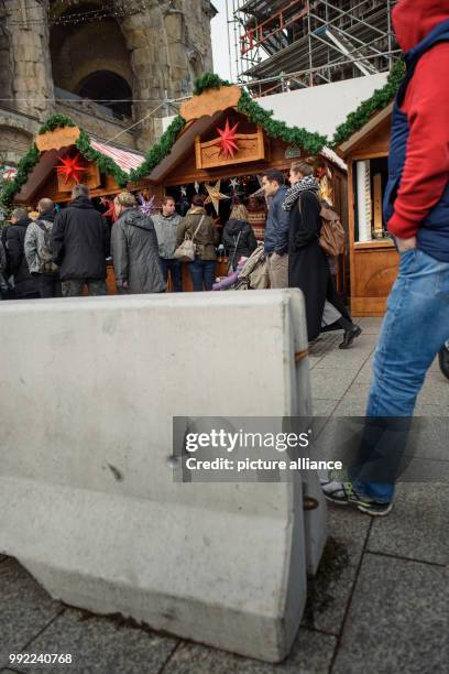 Concrete barriers stand at the entrance to the christmas market at the Kaiser Wilhelm Memorial Church on the Breitscheidplatz square in...