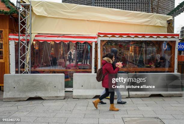 Concrete barriers stand at the entrance to the christmas market at the Kaiser Wilhelm Memorial Church on the Breitscheidplatz square in...