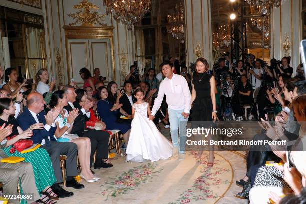 Bernard Danillon, Tania de Bourbon Parme and her husband Louis-Arnaud L'Herbier attend Stylist Liu Lisi acknowledges the applause of the audience at...