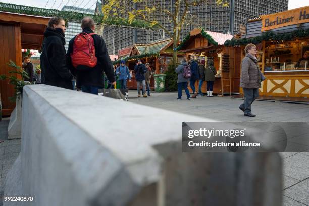 Concrete barriers stand at the entrance to the christmas market at the Kaiser Wilhelm Memorial Church on the Breitscheidplatz square in...