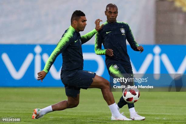 Casemiro and Fernandinho in action during a Brazil training session ahead of the the 2018 FIFA World Cup Russia Quarter Final match between Brazil...