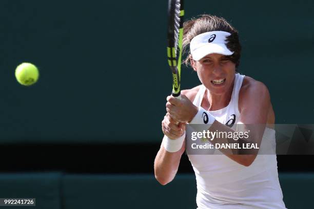 Britain's Johanna Konta returns to Slovakia's Dominika Cibulkova in their women's singles second round match on the fourth day of the 2018 Wimbledon...