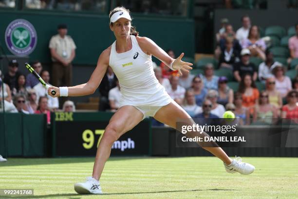 Britain's Johanna Konta returns to Slovakia's Dominika Cibulkova in their women's singles second round match on the fourth day of the 2018 Wimbledon...