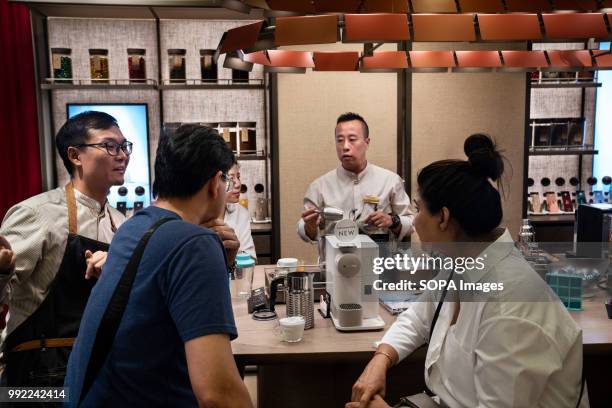 Clients at the Swiss high-end and world leader in coffee capsules brand, Nespresso, store at Hong Kong's ifc shopping mall in Central district..