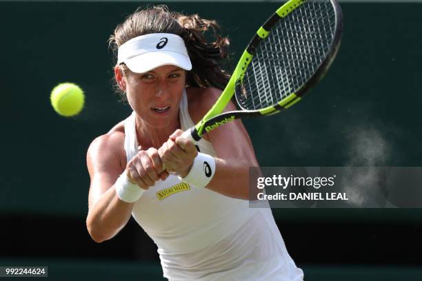 Britain's Johanna Konta returns to Slovakia's Dominika Cibulkova in their women's singles second round match on the fourth day of the 2018 Wimbledon...