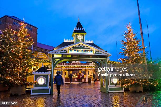 The entrance of the Kiel Christmas market glows in a festive setting in Kiel, Germany, 27 November 2017. The market has been open since 5pm and will...