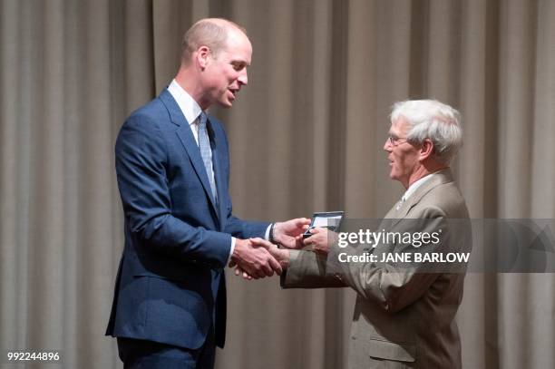 Britain's Prince William, Duke of Cambridge, presents Professor Richard Henderson with the Royal Medal during a visit to the Royal Society of...