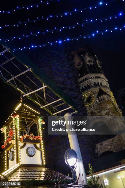 Picture of the Kaiser Wilhelm Memorial Church taken through the lighting decoration of the Christmas market at Breitscheidplatz in Berlin, Germany,...