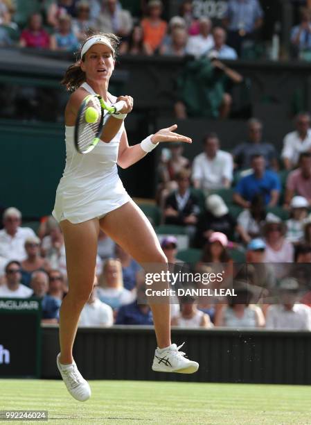 Britain's Johanna Konta returns to Slovakia's Dominika Cibulkova in their women's singles second round match on the fourth day of the 2018 Wimbledon...